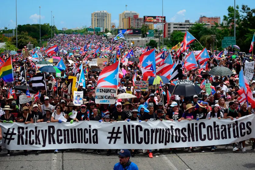 Thousands of Puerto Ricans gather for what many are expecting to be one of the biggest protests ever seen in the U.S. territory, with irate islanders pledging to drive Gov. Ricardo Rossello from office, in San Juan, Puerto Rico, Monday, July 22, 2019. Protesters are demanding Rossello step down for his involvement in a private chat in which he used profanities to describe an ex-New York City councilwoman and a federal control board overseeing the island's finance. (AP Photo/Carlos Giusti)